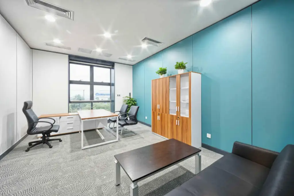 Office with a teal accent wall and professional interior paint design by a commercial painter in Marin County, CA.